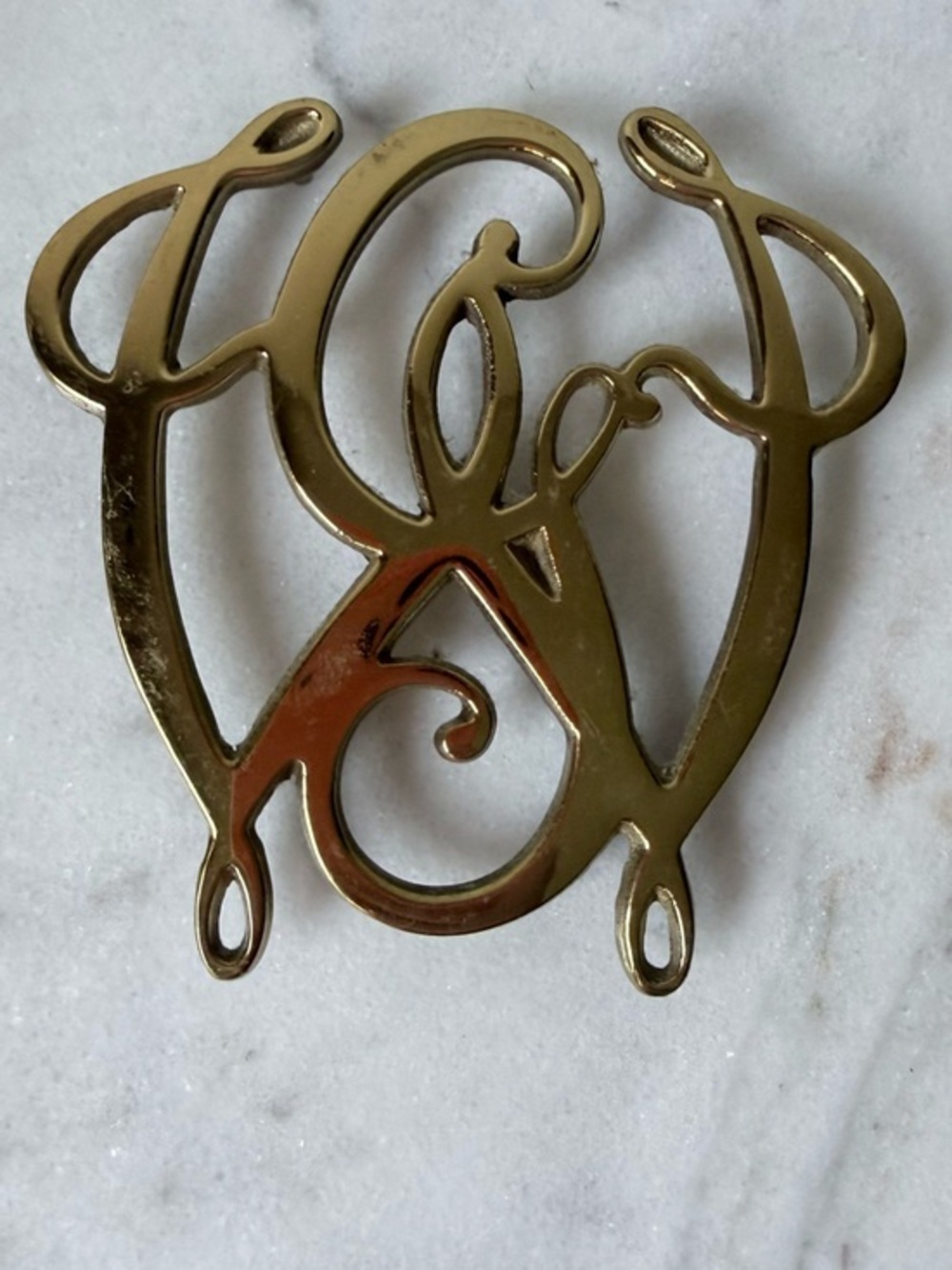 George Washington Cypher solid brass trivet, likely by Virginia Metalcrafters.
